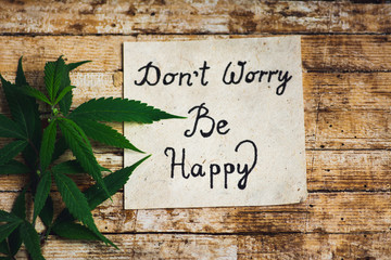 Wall Mural - Dont worry be happy note and marijuana leafs