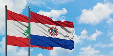 Lebanon and Paraguay flag waving in the wind against white cloudy blue sky together. Diplomacy concept, international relations.
