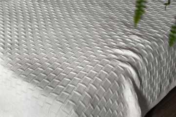  White knitted blanket on bed 