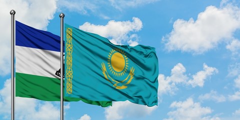 Lesotho and Kazakhstan flag waving in the wind against white cloudy blue sky together. Diplomacy concept, international relations.