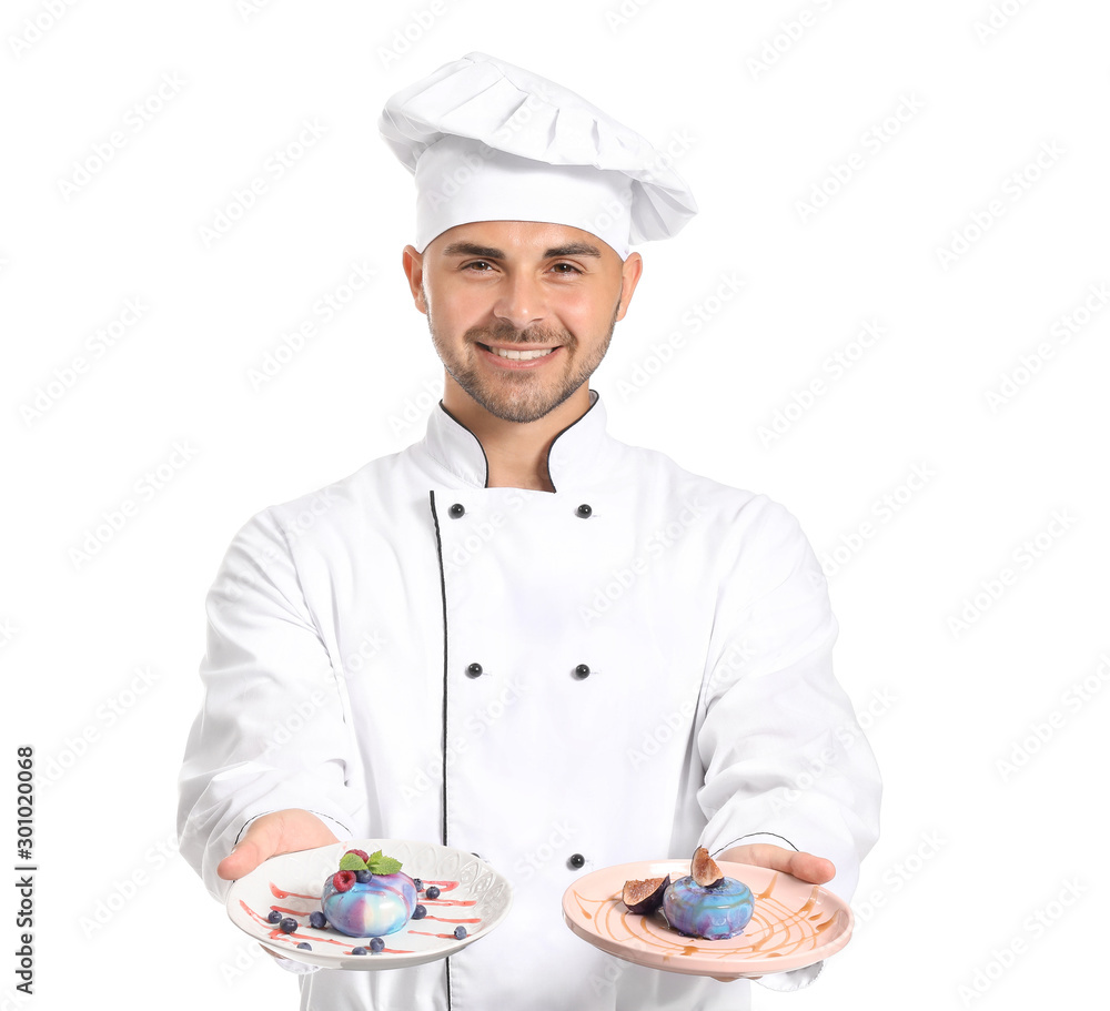 Male confectioner with tasty desserts on white background