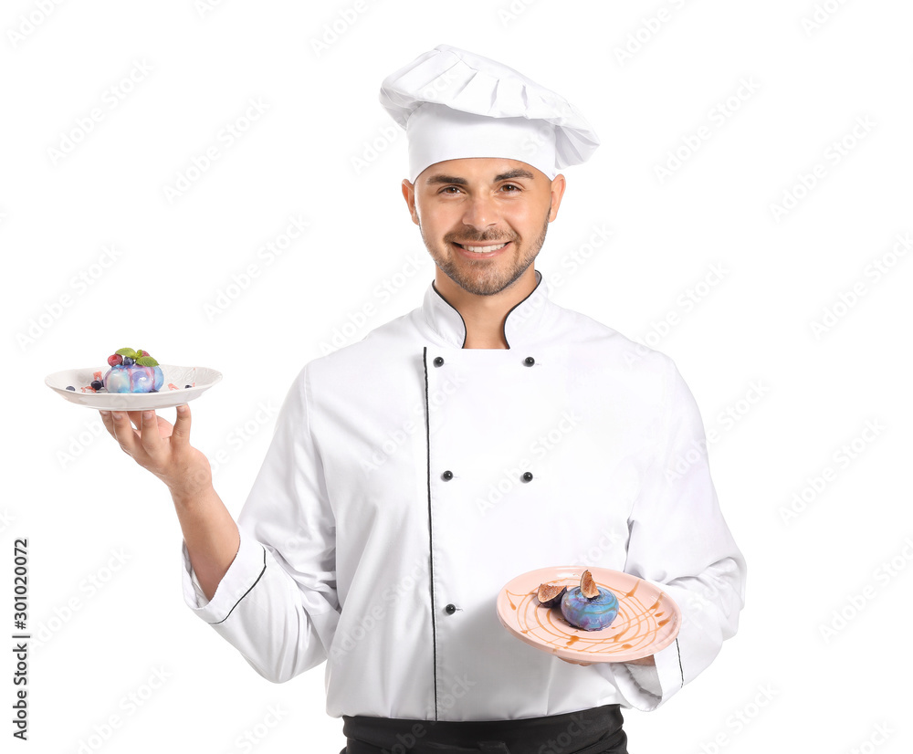 Male confectioner with tasty desserts on white background
