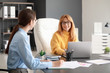 © Pixel-Shot - Mature businesswoman and her assistant working in office