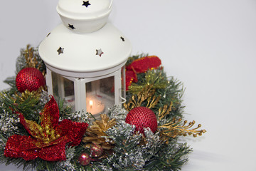 Christmas wreath lantern with fire on a white background.