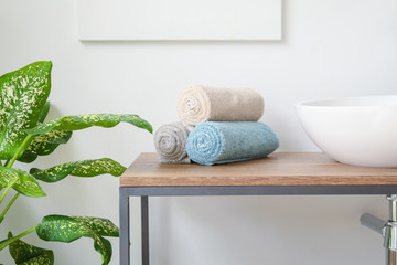 Poster - Rolled clean towels on table in bathroom