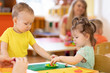 © Oksana Kuzmina - Kids group making arts and crafts in kindergarten. Children on lesson in day care centre