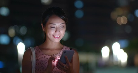 Wall Mural - Woman use of mobile phone at night