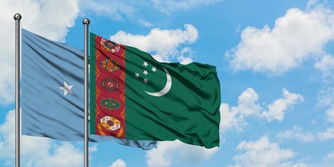 Micronesia and Turkmenistan flag waving in the wind against white cloudy blue sky together. Diplomacy concept, international relations.