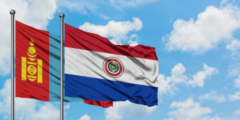 Mongolia and Paraguay flag waving in the wind against white cloudy blue sky together. Diplomacy concept, international relations.