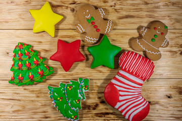 Wall Mural - Tasty festive Christmas gingerbread cookies on wooden table. Top view