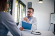 © bnenin - Portrait of a handsome doctor consulting a patient.