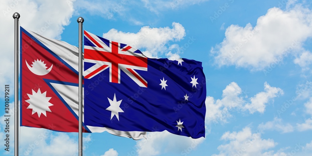 Nepal and Australia flag waving in the wind against white cloudy blue ...