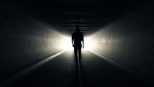 Man Walking In Tunnel To The Light