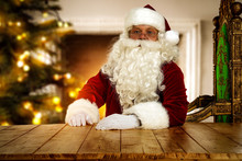 Santa Claus Sittng In Big Comfortable Throne Chair And Resting In Living Room And Thinking About The List Of Gifts. Fireplace And Christmas Tree Background. Comfortable And Cozy Place In Home Interior
