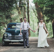 © jozzeppe777 - bride and groom walking in the forest near the car