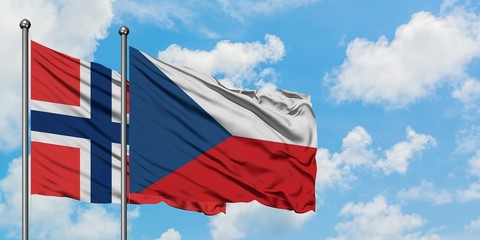 Norway and Czech Republic flag waving in the wind against white cloudy blue sky together. Diplomacy concept, international relations.