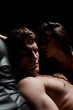 © LIGHTFIELD STUDIOS - beautiful seductive couple sitting on sofa in dark room