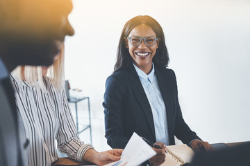 Wall Mural - Young African American businesswoman laughing with colleagues du