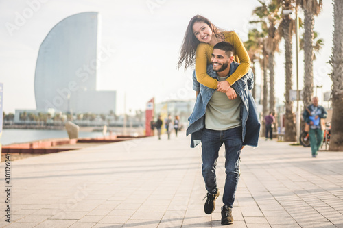 Happy couple having fun walking in Barcelona - Young people enjoying time togeth Wallpaper Mural