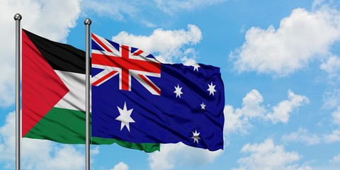 Palestine and Australia flag waving in the wind against white cloudy blue sky together. Diplomacy concept, international relations.