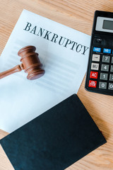 Wall Mural - top view of paper with bankruptcy letters near calculator and gavel