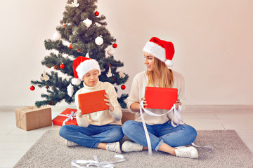 Wall Mural - Single parent and holidays concept - Portrait of mother and son celebrating christmas at home on christmas eve