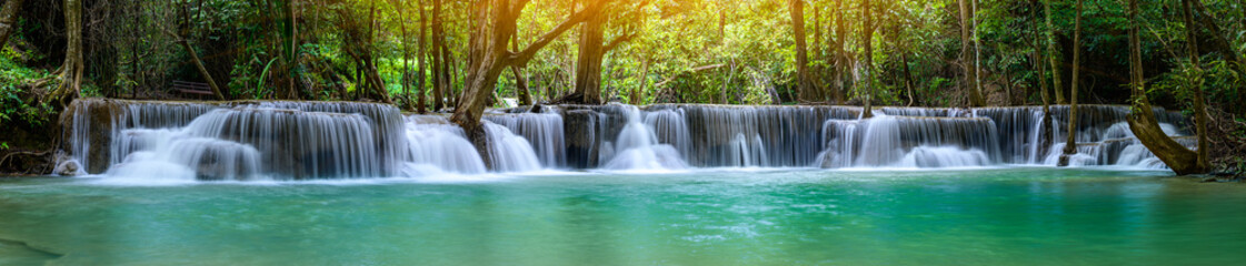 A beautiful waterfall deep in the tropical forest, steep mountain adventure in the rainforest.