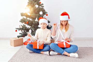 Wall Mural - Single parent and holidays concept - Portrait of mother and son celebrating christmas at home on christmas eve