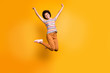 Full length body size photo of cheerful rejoicing curly wavy casual beautiful youngster ecstatic about buying new orange trousers striped t-shirt isolated bright color background