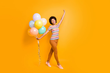 Poster - Full length photo of positive cheerful girl hold many baloons have summer free time walk with her boyfriends feel content wear striped t-shirt outfit isolated over yellow color background