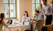 © Zoran Zeremski - Group of young business people working together while sitting at the office desk.