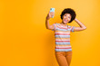 Photo of wavy cute nice charming pretty sweet girlfriend wearing pants trousers orange taking selfie excited about having bought new phone isolated over vibrant color background