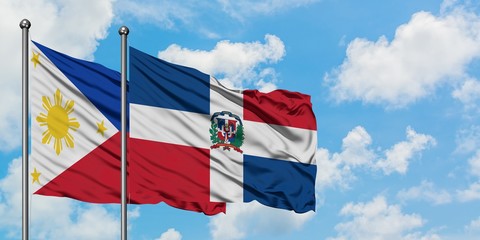 Philippines and Dominican Republic flag waving in the wind against white cloudy blue sky together. Diplomacy concept, international relations.