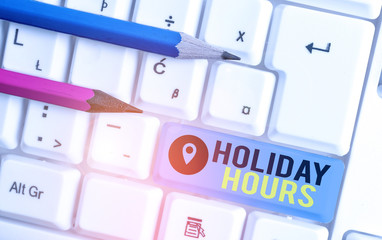 Word writing text Holiday Hours. Business photo showcasing employee receives twice their normal pay for all hours White pc keyboard with empty note paper above white background key copy space