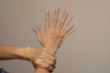 Person holding trembling hand, nervous gesture