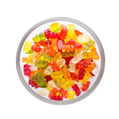 Wall Mural - colorful jelly candy in a bowl isolated on white background, view from above