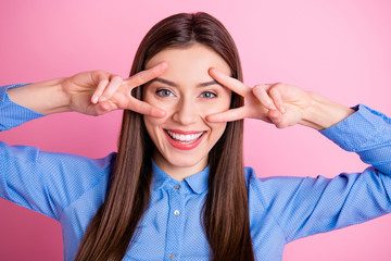 Sticker - Close up photo of pretty lady showing v-sign symbols near eyes saying hello to friends wear blue dotted shirt isolated pink color background