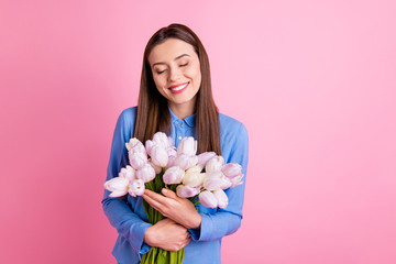 Sticker - Photo of amazing lady holding big fresh white tulips bunch in hands closing eyes from joy wear blue dotted shirt isolated pink color background