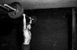 © Srdjan - Young strong fit muscular sweaty man with big muscles doing barbell weight lifting cross training workout in the gym dark image real people black and white