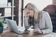 © deagreez - Photo of amazing blond business lady holding head on hand tired feel dizzy overwhelmed assistant notebook table sitting chair formalwear blazer modern office