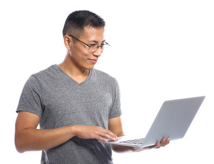 Male Asian programmer with laptop on white background