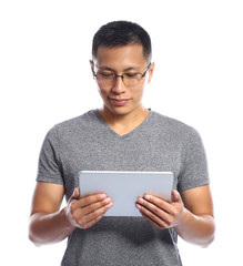 Male Asian programmer with tablet computer on white background