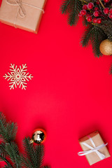 Wall Mural - Vertical top above high angle view photo of empty space among snowflake gifts and fir branches with christmas toys isolated red color vivid background
