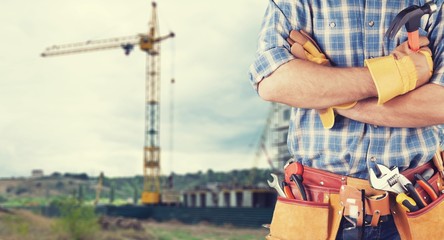 Poster - Young man worker in uniform with  tools