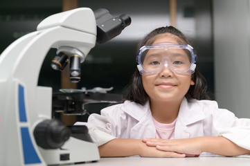 Wall Mural - happy little child smile and learning in school laboratory