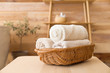Basket with clean towels on table in bathroom