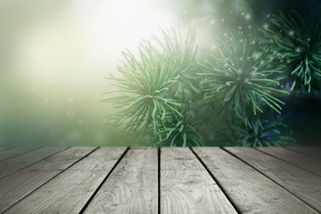 Wall Mural - Christmas background. Blurred fir tree and empty wooden table.