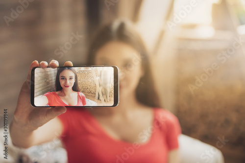 Fotografía Young woman taking selfie using phone