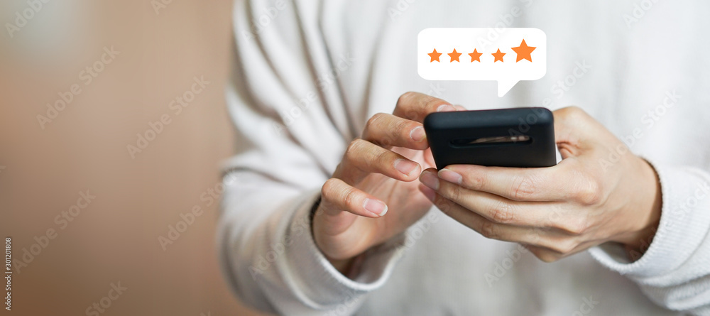 close up on customer man hand pressing on smartphone screen with gold five star rating feedback icon and press level three rank (good) for give score point to review the service business concept	 - obrazy, fototapety, plakaty 