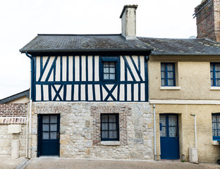 typical Normandy architecture house front with stone and half-timbered facade